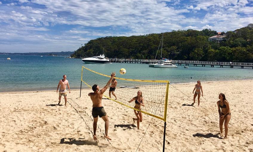 Enjoying A Game Of Beach Volleyball At The Final Beach Stop